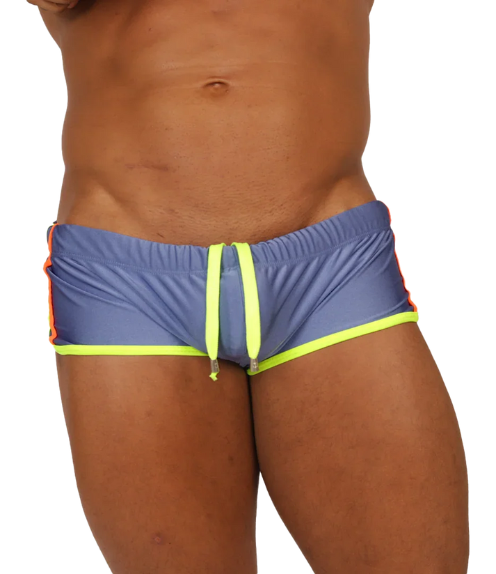 Close-up of a blue Gigo Nice swim trunk with neon yellow leg trim and drawstring, and orange side details.