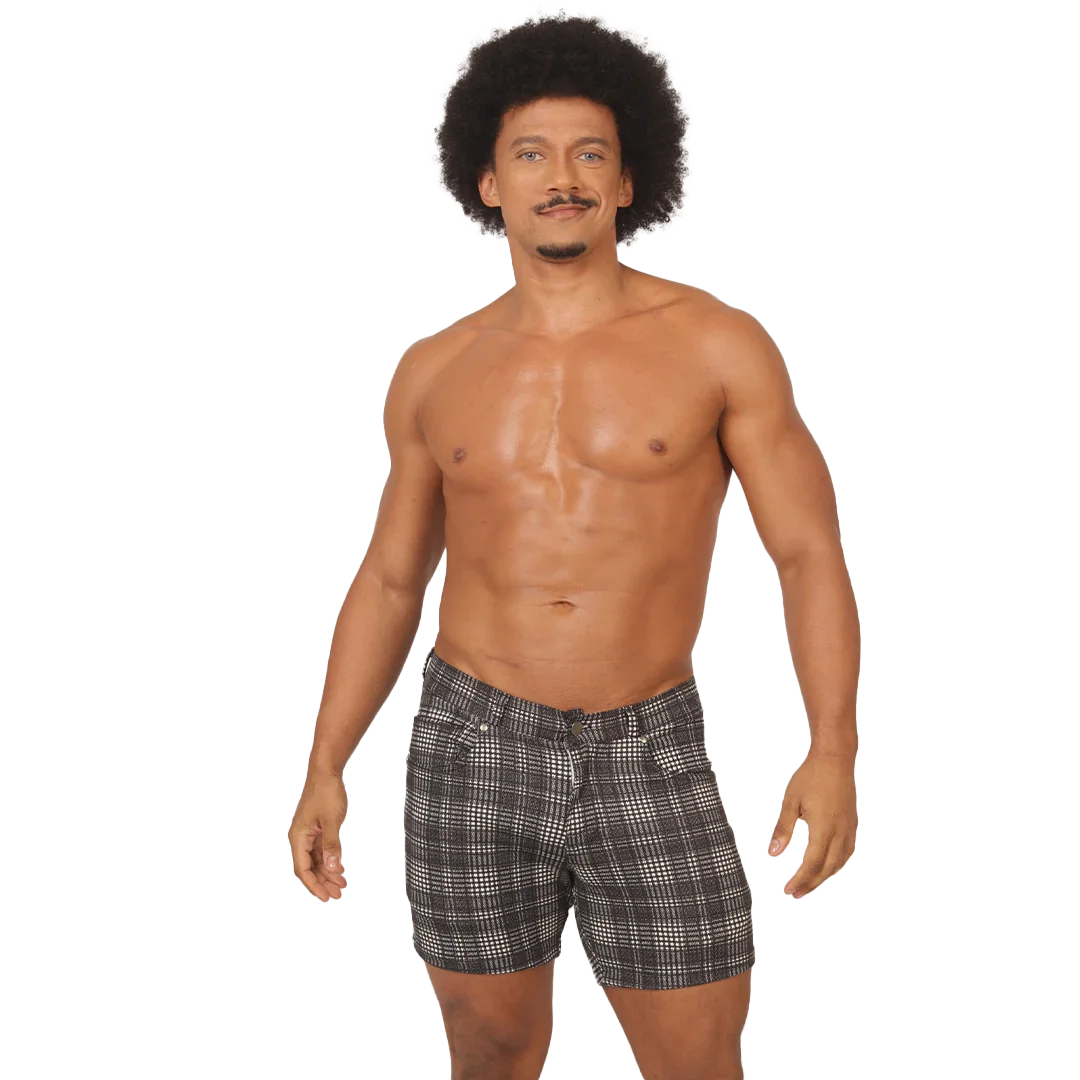 Adult male model wearing gray checkered Gigo men’s shorts, showing a clean warm weather silhouette, short length, fabric structure and casual sportwear styling.